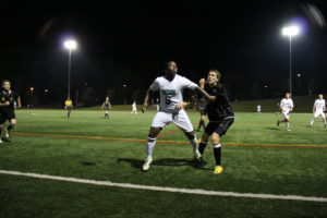Freshman Franklin Robinson pushes his way to the ball against the Petrels