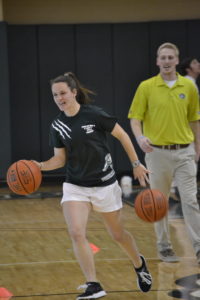 Cydney Goodwin dribbles down court as a part of a basketball skills challenge game.