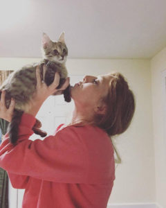 Senior biology major Sabrina Page lifts up another one of her cats, Giselle, when she was a kitten.