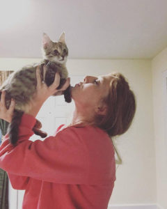 Senior biology major Sabrina Page lifts up another one of her cats, Giselle, when she was a kitten.